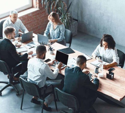 multiethnic-business-team-working-together-sitting-in-modern-office-panorama.jpg